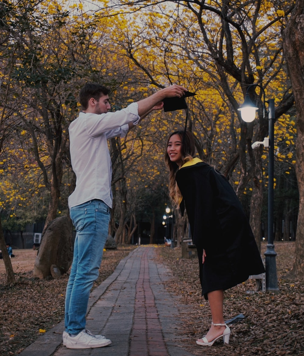 Tice putting graduation cap on babe's head